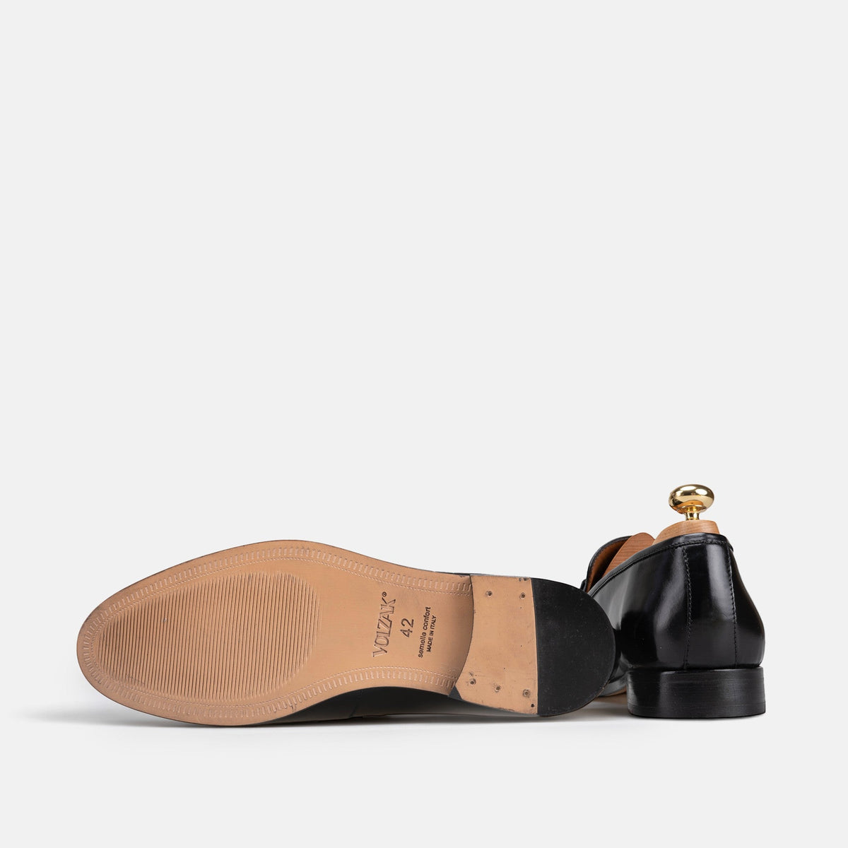 VOLZAK black leather dress shoe showing the tan leather sole with brand logo and heel detail