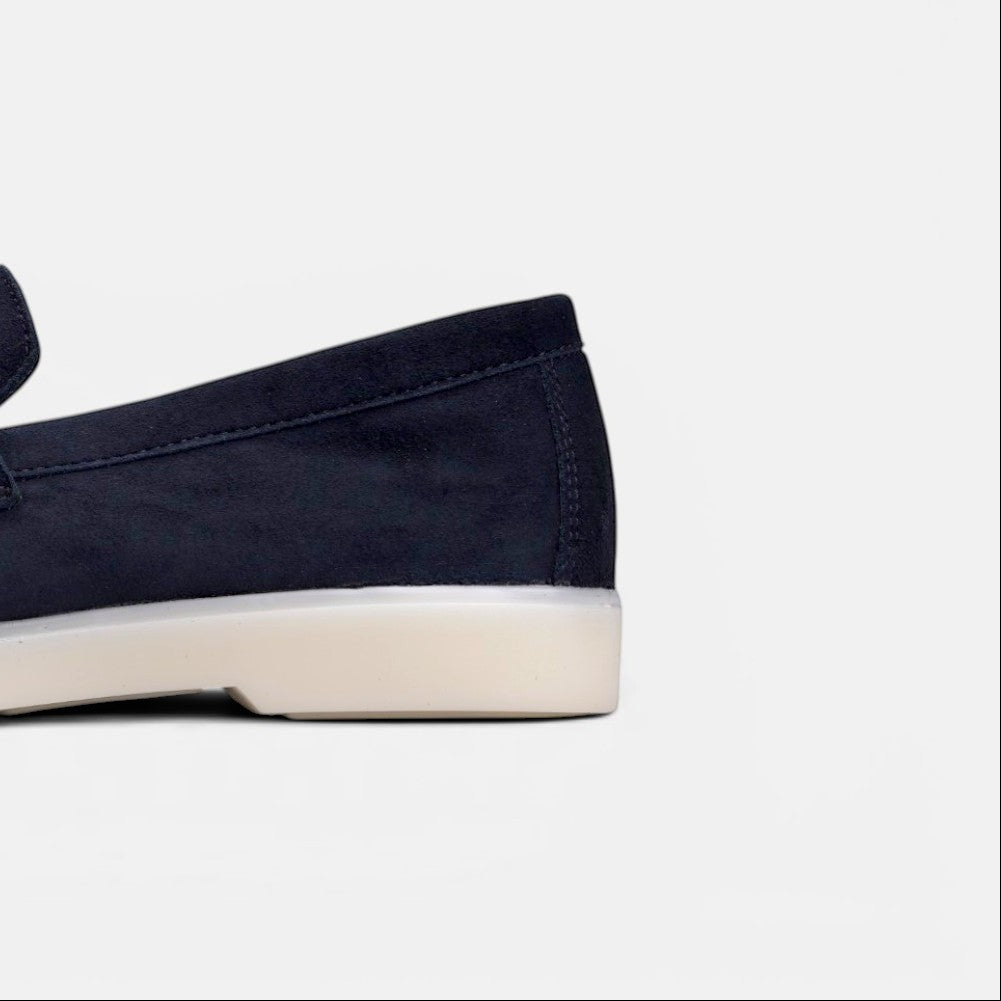 Close-up of the heel of a VOLZAK blue suede moccasin with a white rubber sole