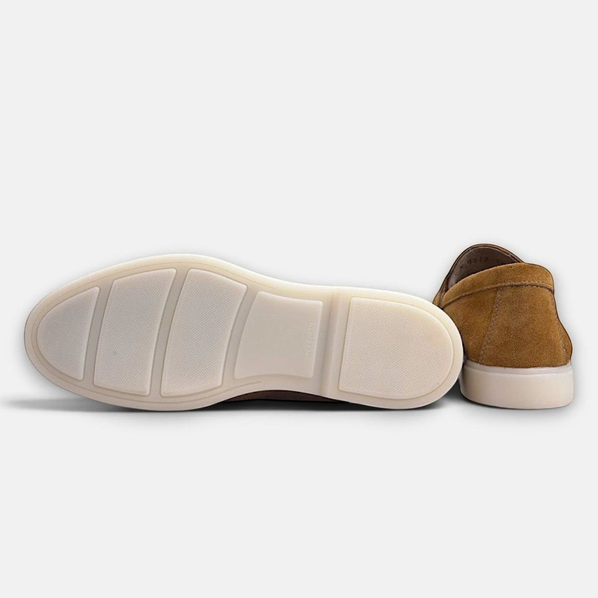 VOLZAK camel suede moccasin showing the white rubber sole and heel detail against a plain background