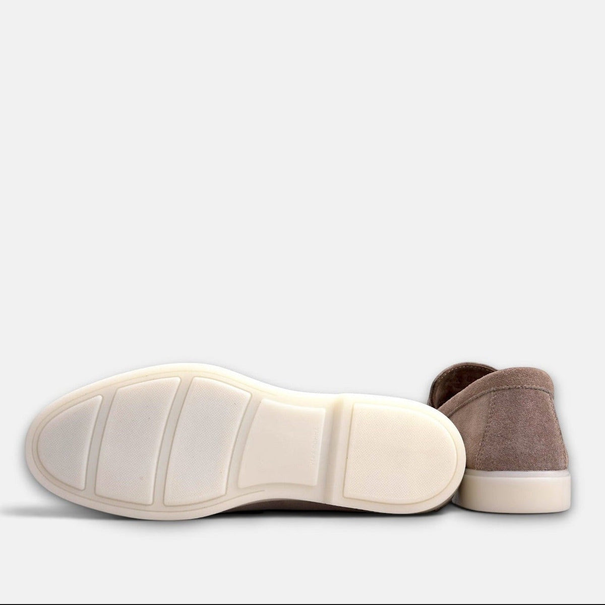 VOLZAK taupe suede moccasin showing the white rubber sole and heel detail against a plain background