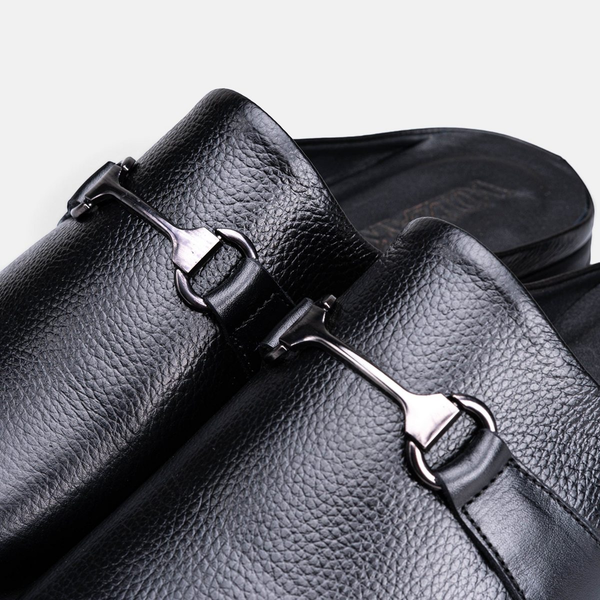 VOLZAK black grained leather mule with a metallic horsebit detail and comfortable rubber sole