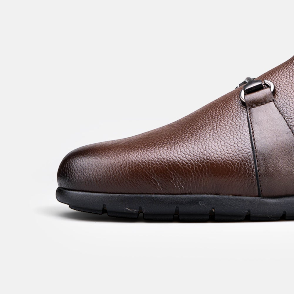 VOLZAK brown grained leather mule with a black rubber sole and metal buckle detail