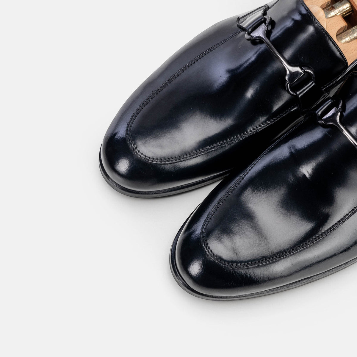 VOLZAK black leather loafers with a polished finish and metal bit detail, featuring a classic slip-on design.